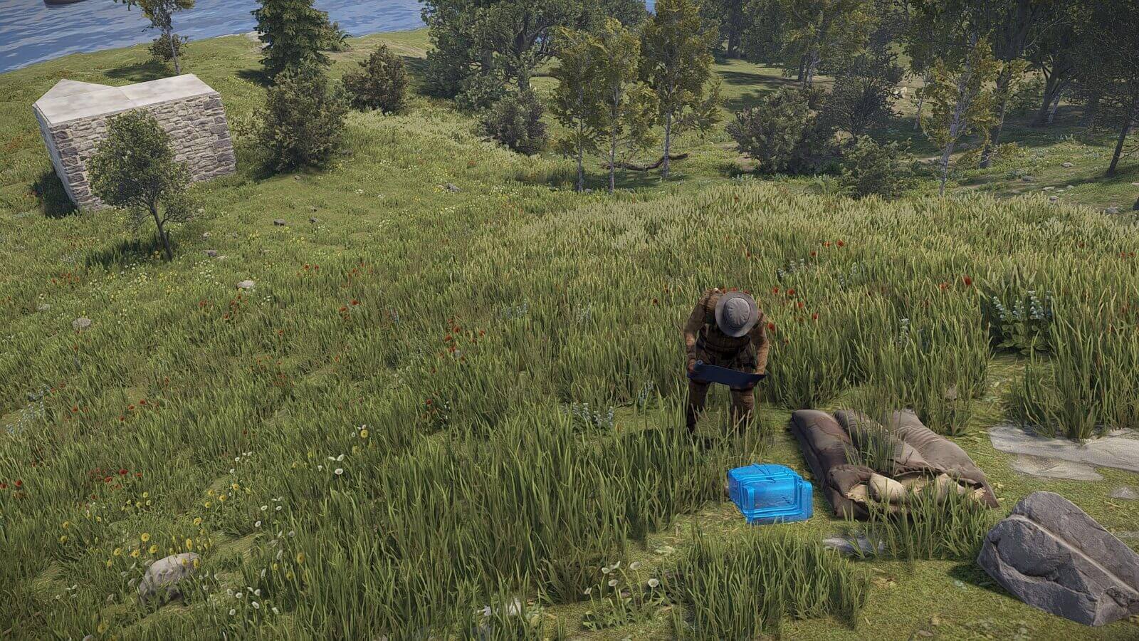 Placing a stash on the ground next to a sleeping bag for extra loot storage and distribution.