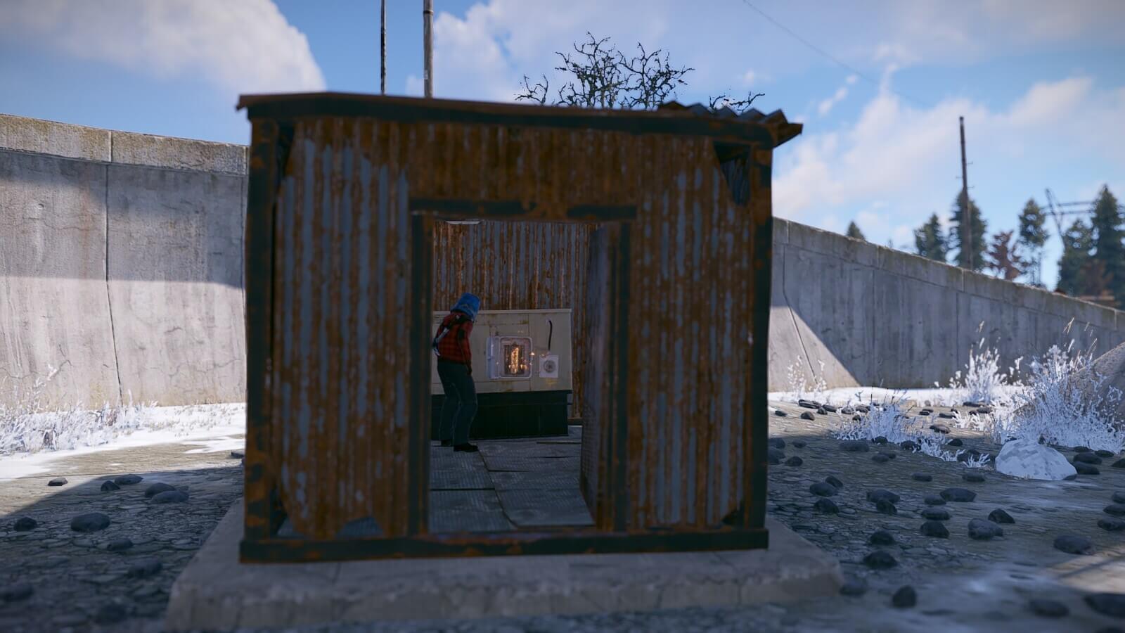 A player in Rust placing the fuse inside of the fuse box at the Satellite Dish monument.