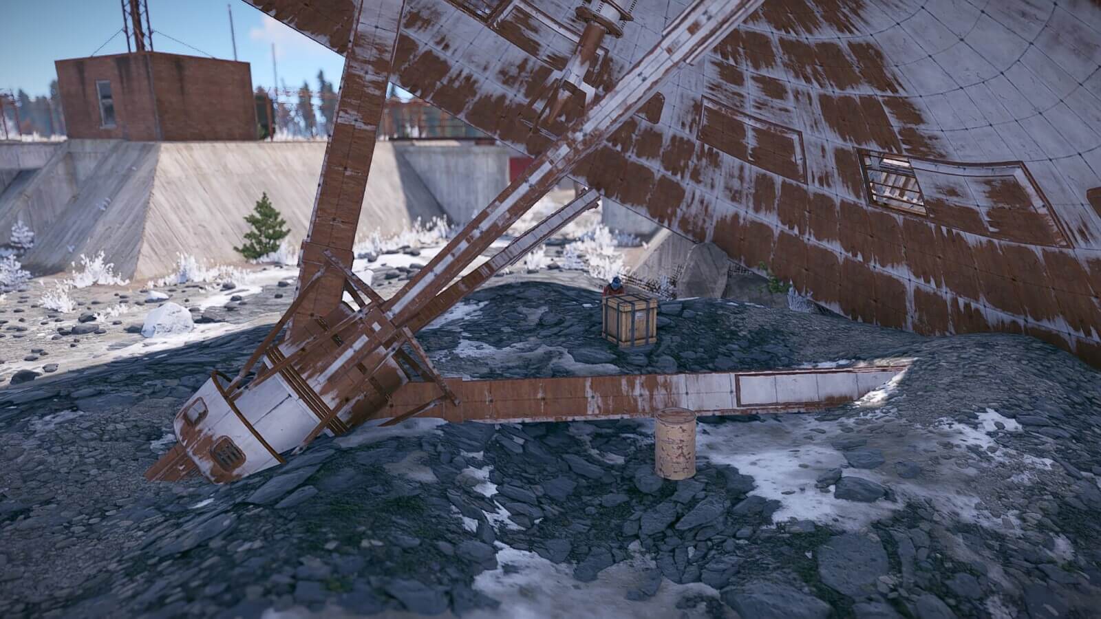 Under the broken satellite dish you'll find a crate spawn along with a barrel spawn or two.